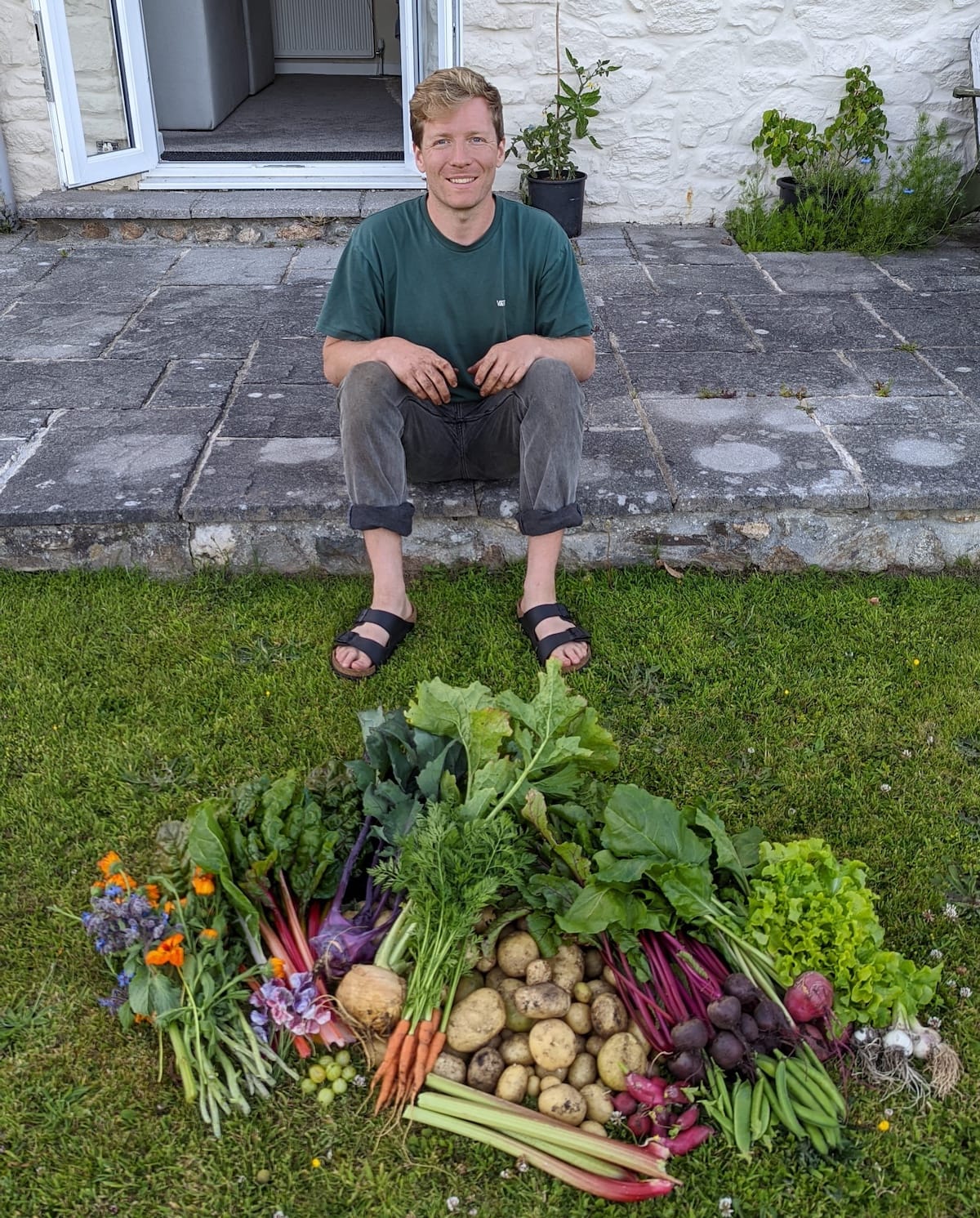 Jamie in the garden with his harvest of vegetables